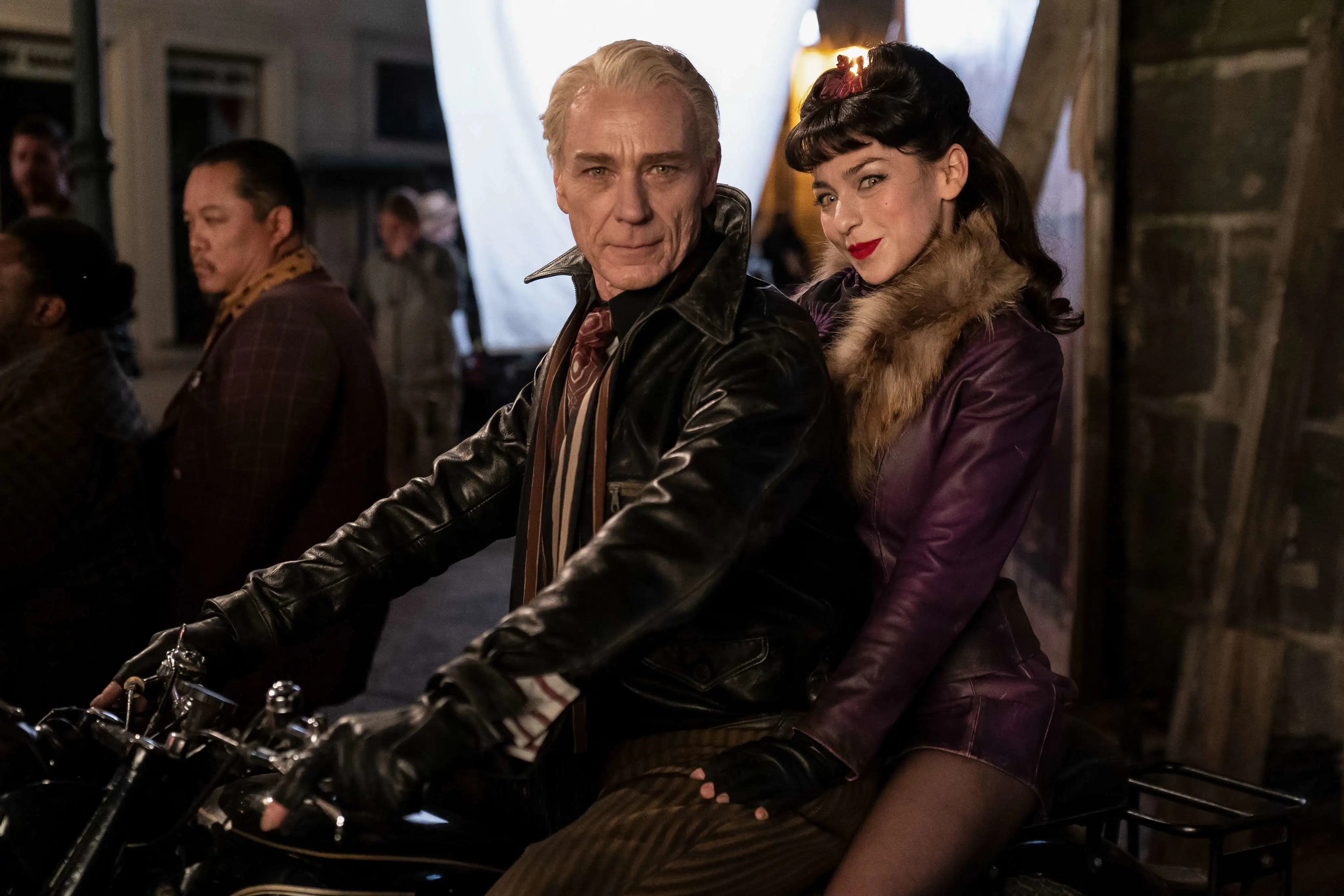 BTS Foto Interview with the Vampire. Zwei Schauspieler sitzen auf einem Motorrad und sehen in die Kamera.